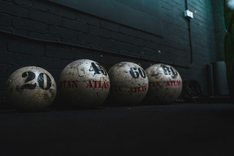 Weathered Atlas stones with numbers, used in strongman competitions at Strongman Blog.
