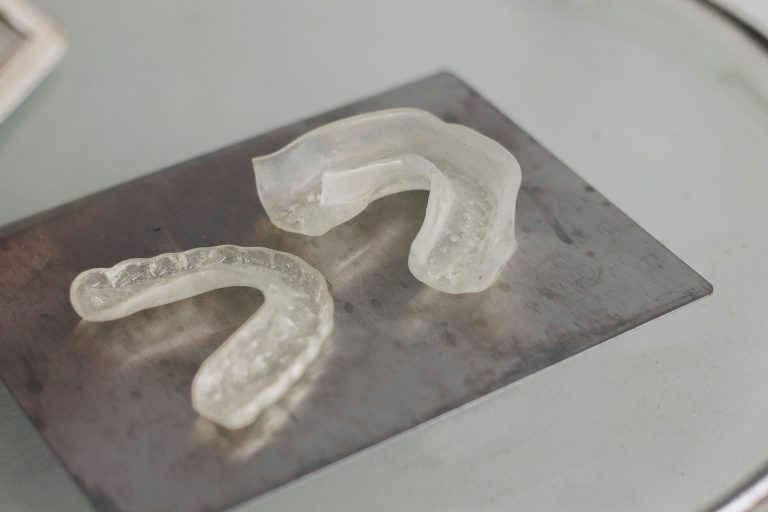 Close-up of durable, clear gum guards used for strongman training and jaw protection.