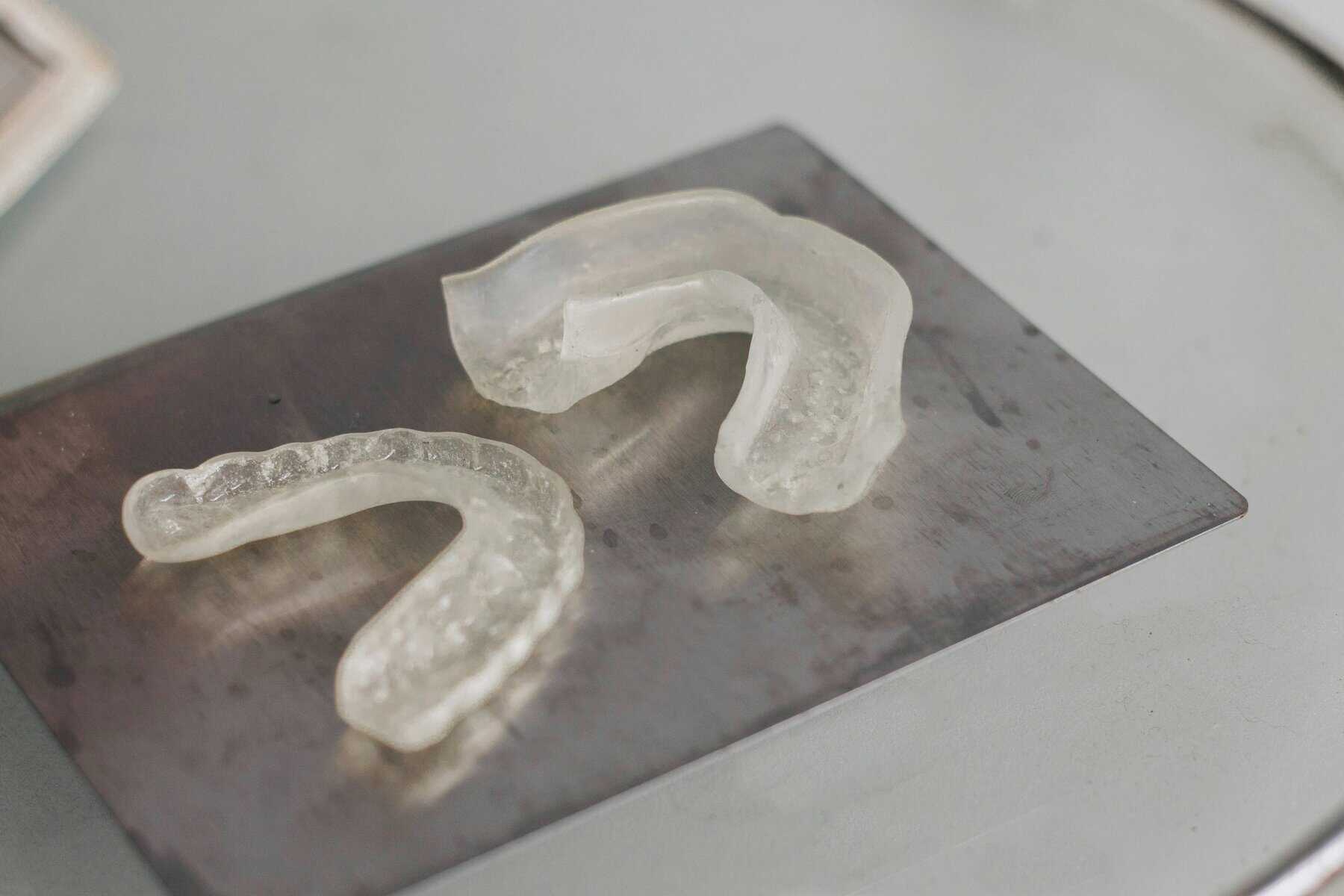 Close-up of durable, clear gum guards used for strongman training and jaw protection.